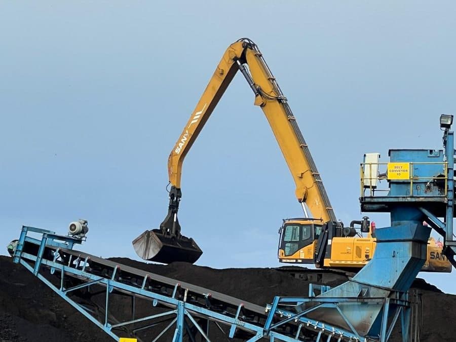 Material handler with grab over a coal stockpile