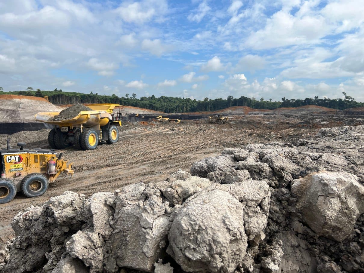 Haul truck carrying overburden across the pit